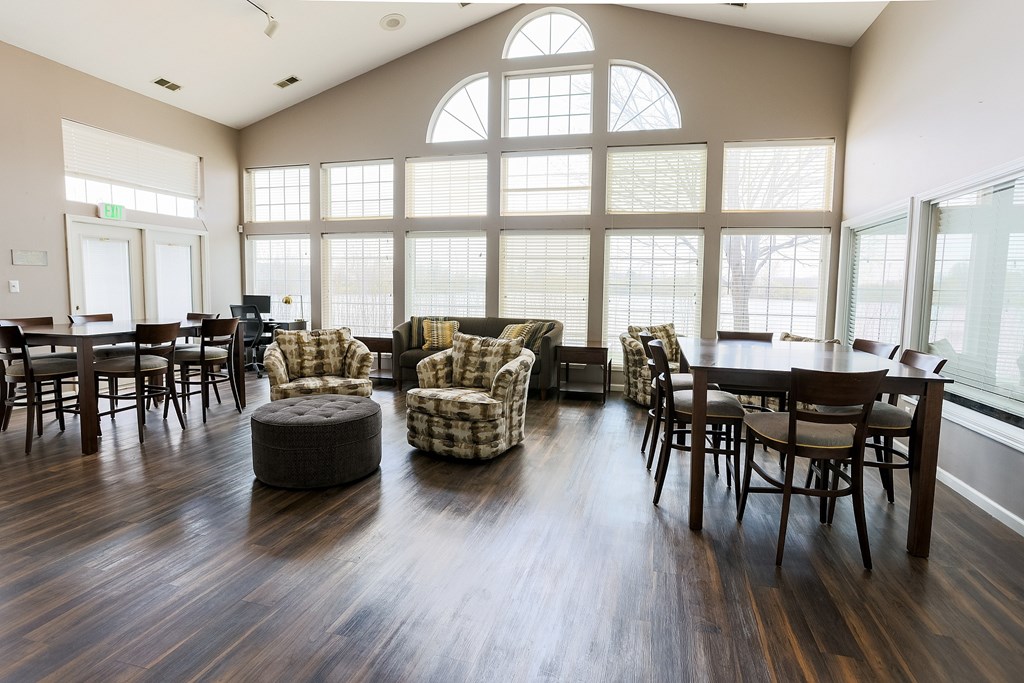 A large room with wooden floors and a large window.