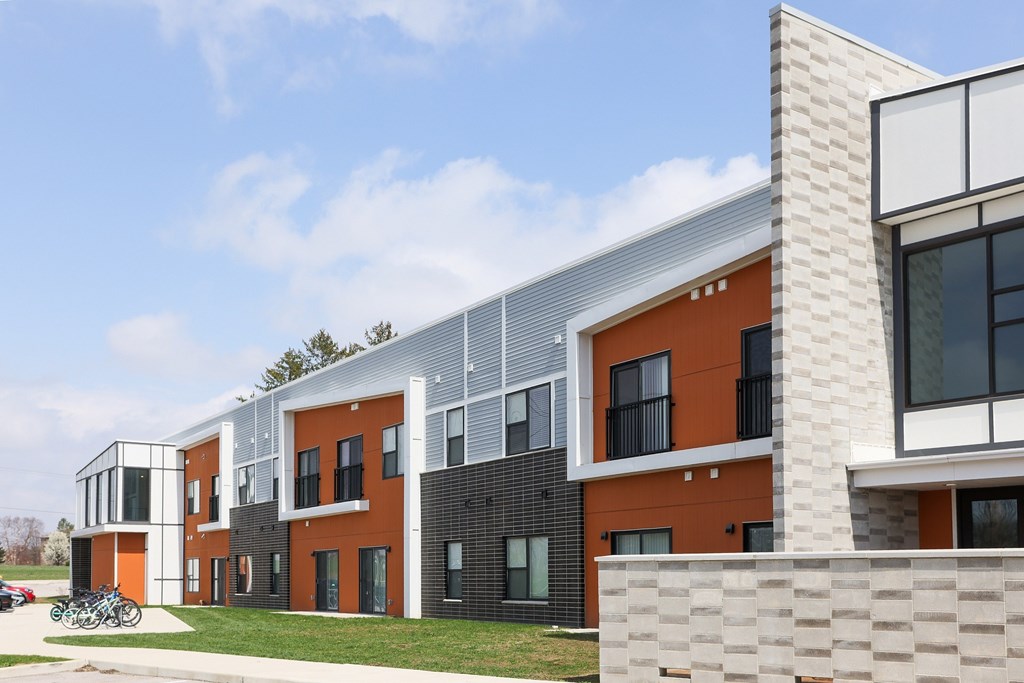 A modern building with orange and grey exterior.