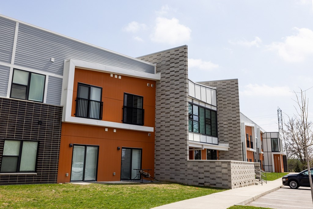 A modern building with orange and grey exterior.