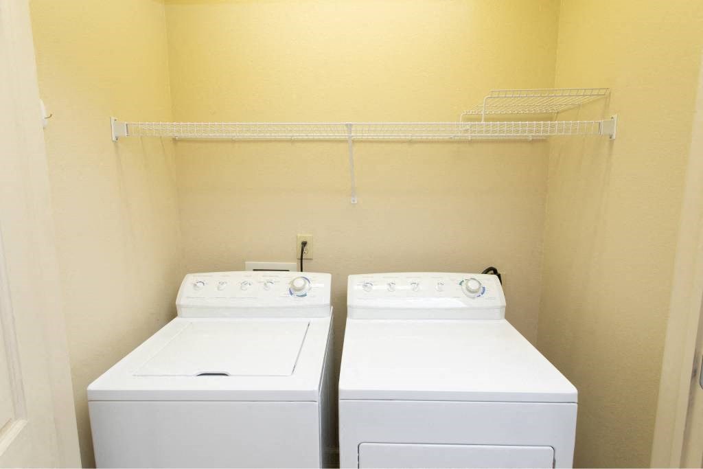 A small laundry room with a washer and dryer.
