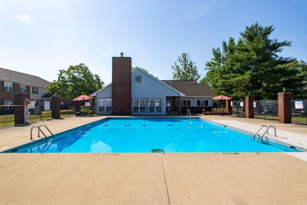 A large blue swimming pool in front of a building.