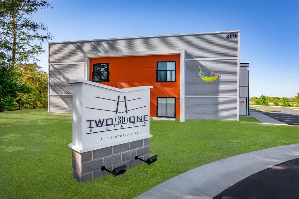 A building with a sign that says "Two 30 One" in front of it.