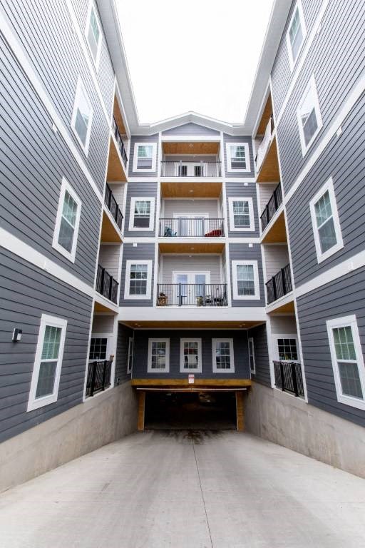 Apartment building with garage parking ramp