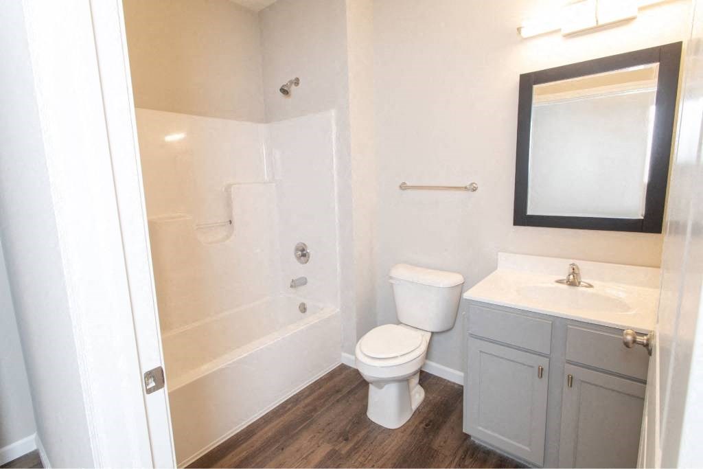 A white toilet sits next to a sink in a small bathroom.