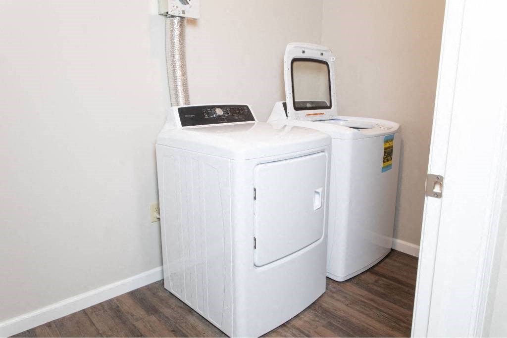 A white portable oxygen concentrator sits in a corner of a room.