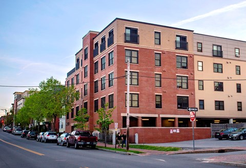 A red brick building with a stop sign in front of it.