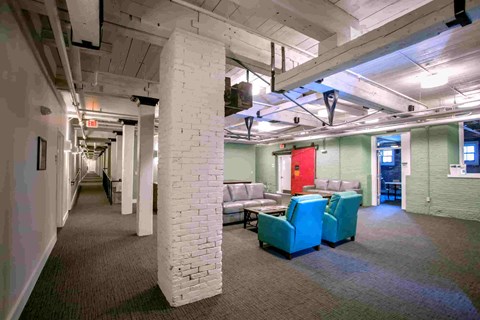 A room with white pillars and a red door.