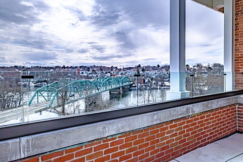 A view from a window of a bridge over a river.