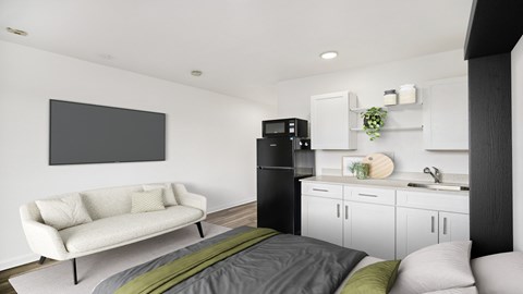 A modern living room with a white couch and a grey bed.