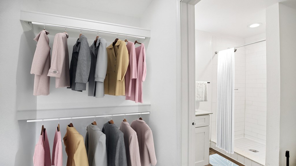 Clothes hanging on a rack in a room.