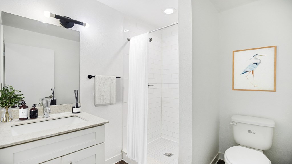 A bathroom with a white toilet and a white sink.