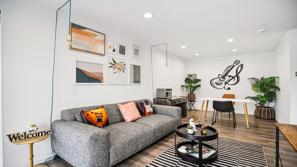 A living room with a grey couch and a coffee table.