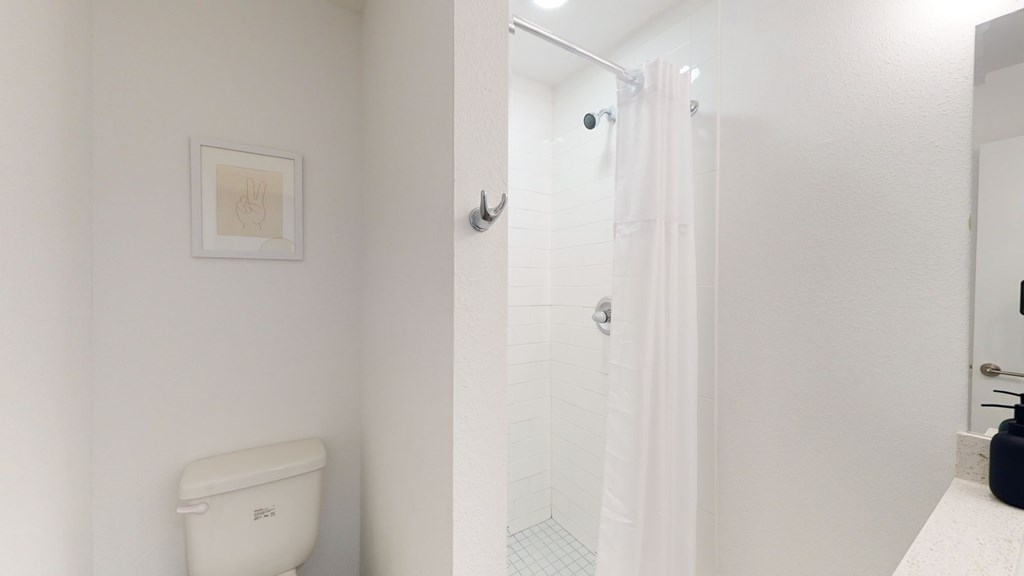 A white toilet is in a small bathroom.