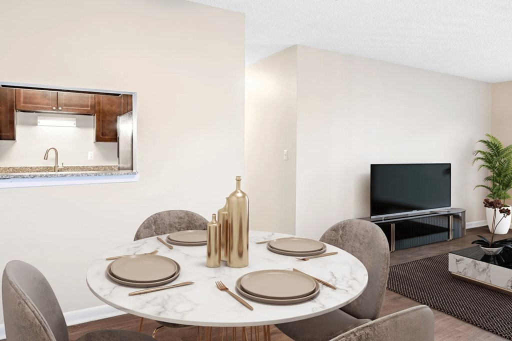 A dining table set with plates and cutlery is in the foreground of a modern dining room.