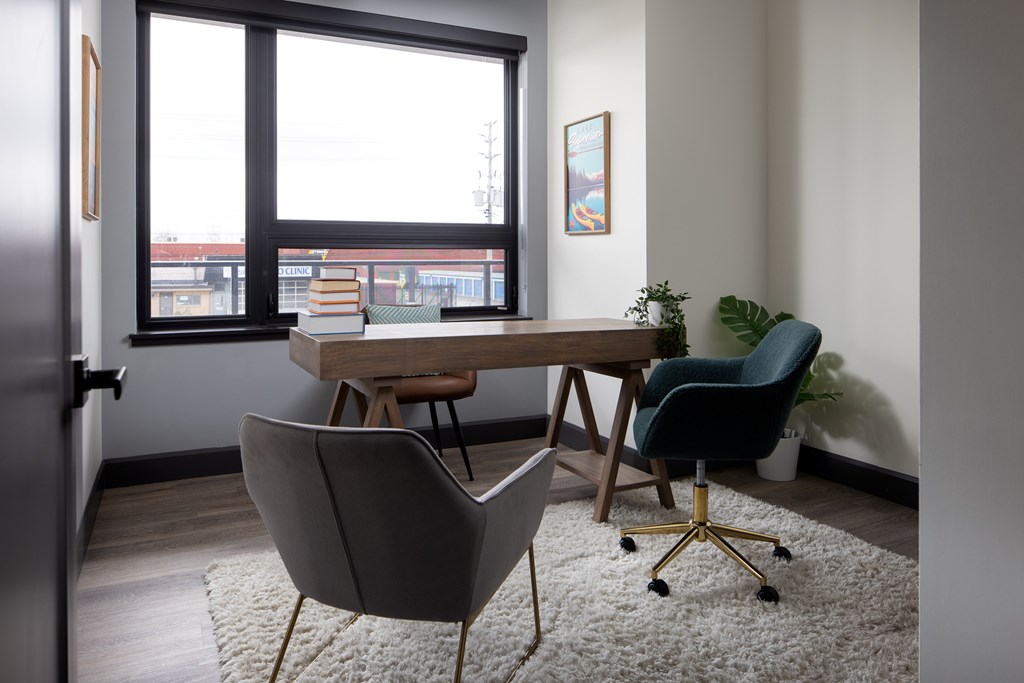Large den featuring work desk and two chairs for home office at Damask, Windsor, ON