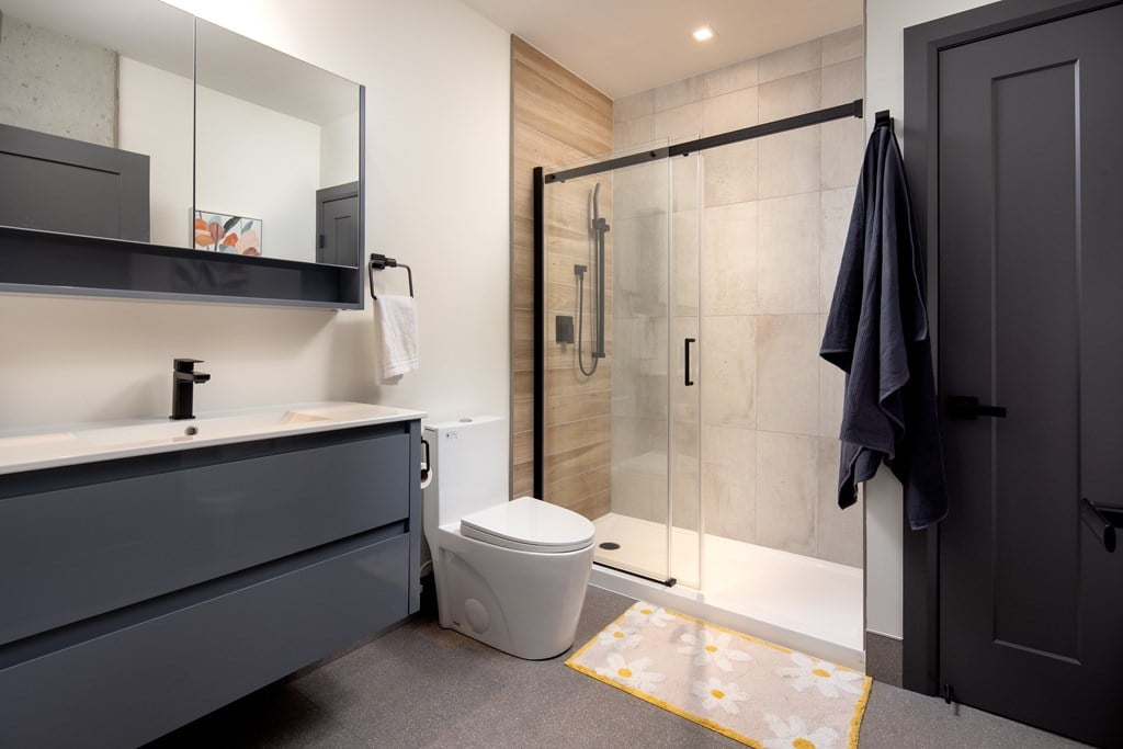 Modern bathroom featuring walk-in shower and floating vanity at Damask, Windsor Ontario