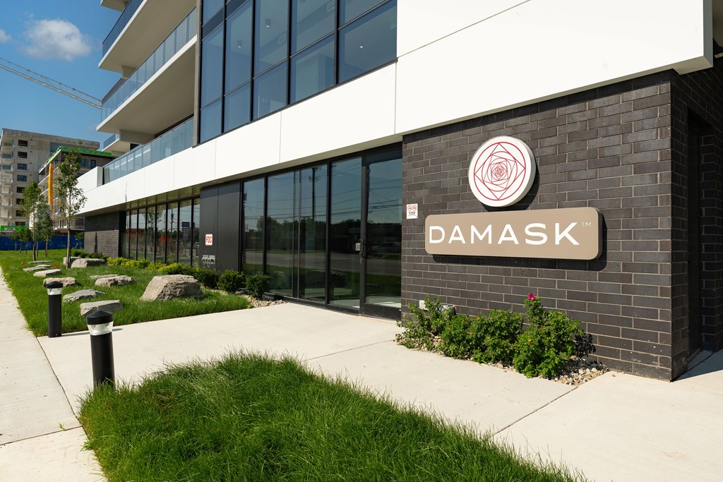 A modern building with the word "Damask" on its facade.