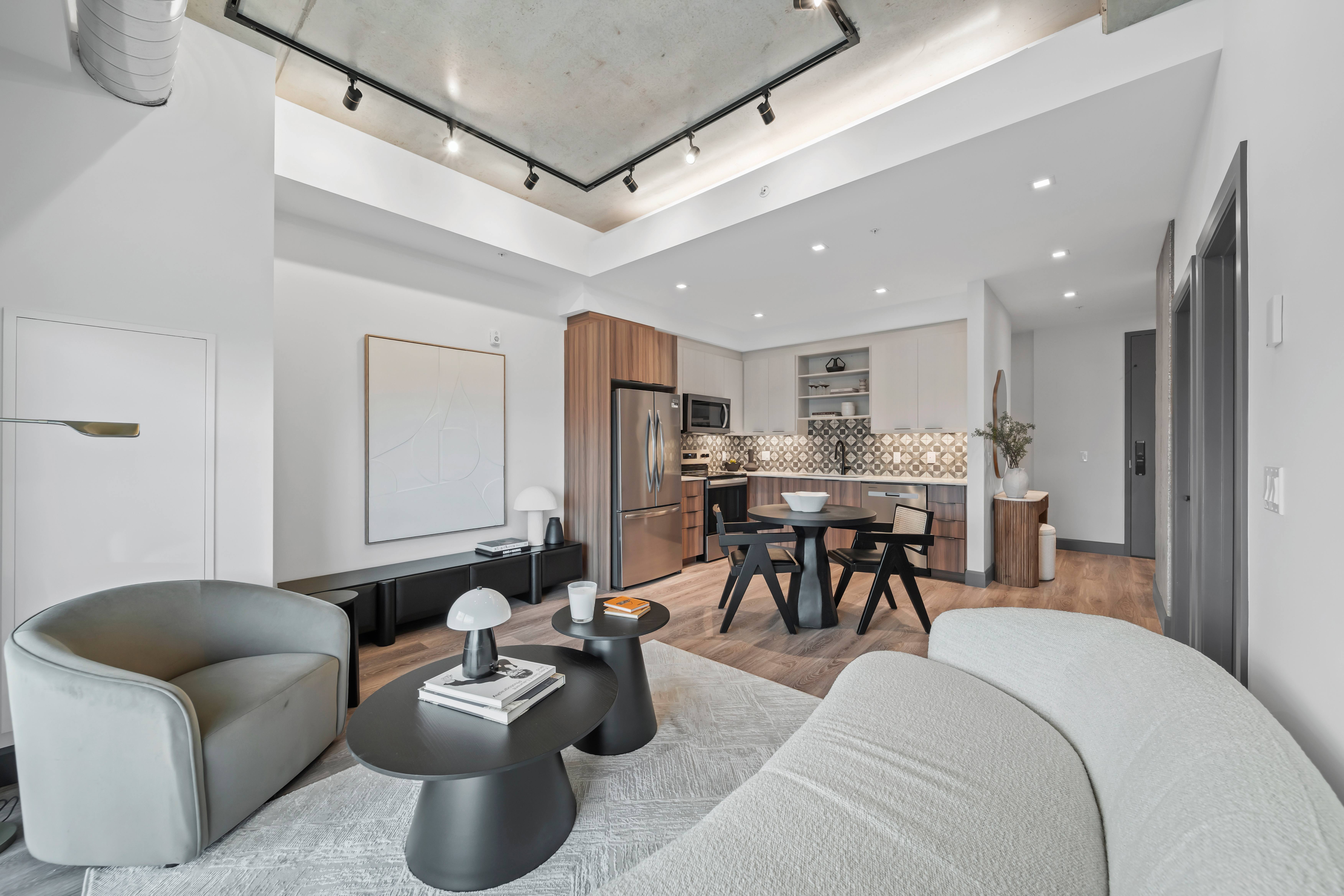 A modern living room with a grey sofa and a black coffee table.