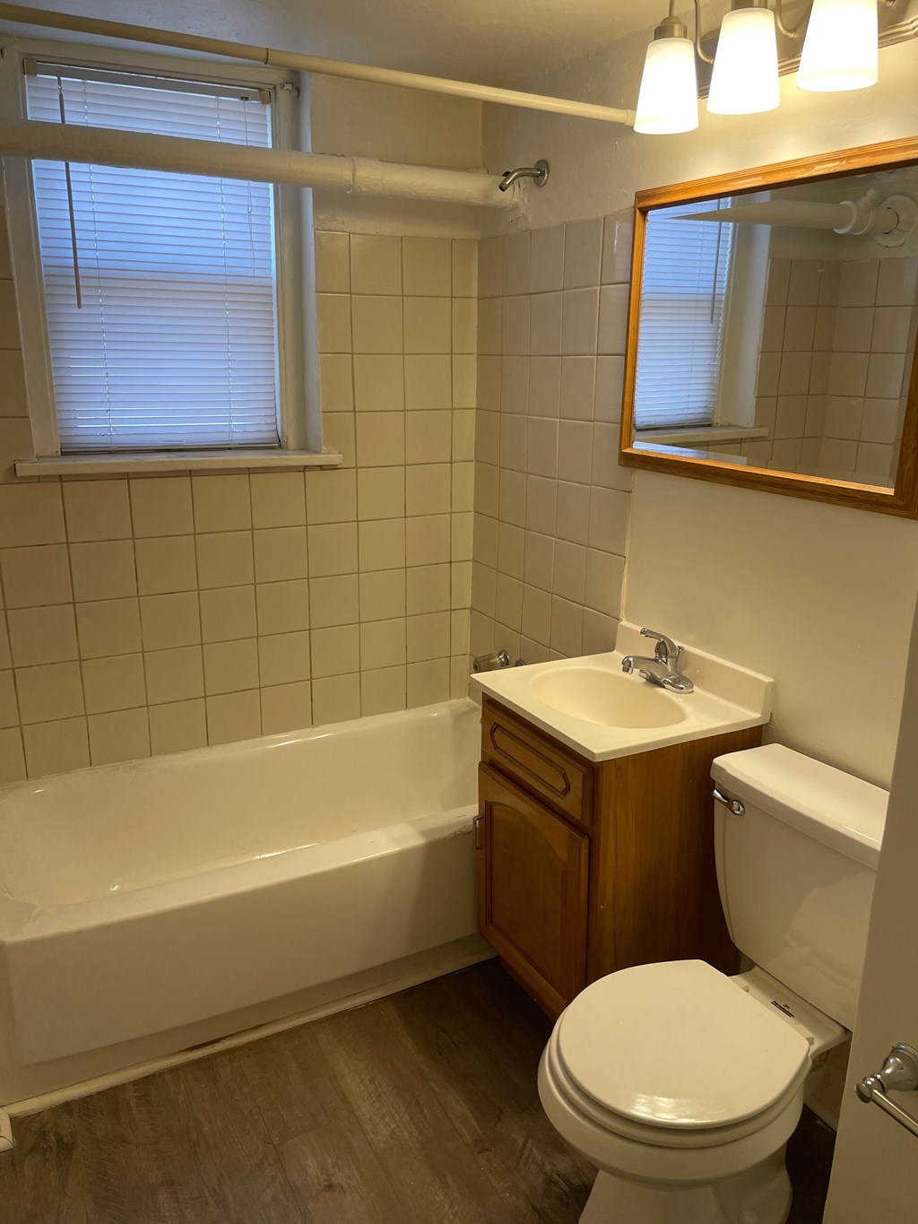 A white toilet sits next to a sink in a bathroom.
