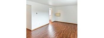 A room with wooden floors and white walls.