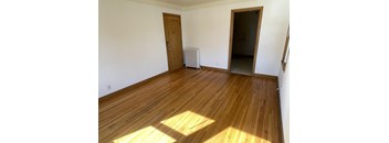 A room with wooden floors and a door.