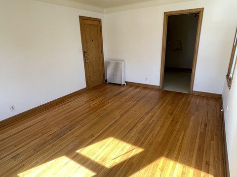 A room with wooden floors and a door.