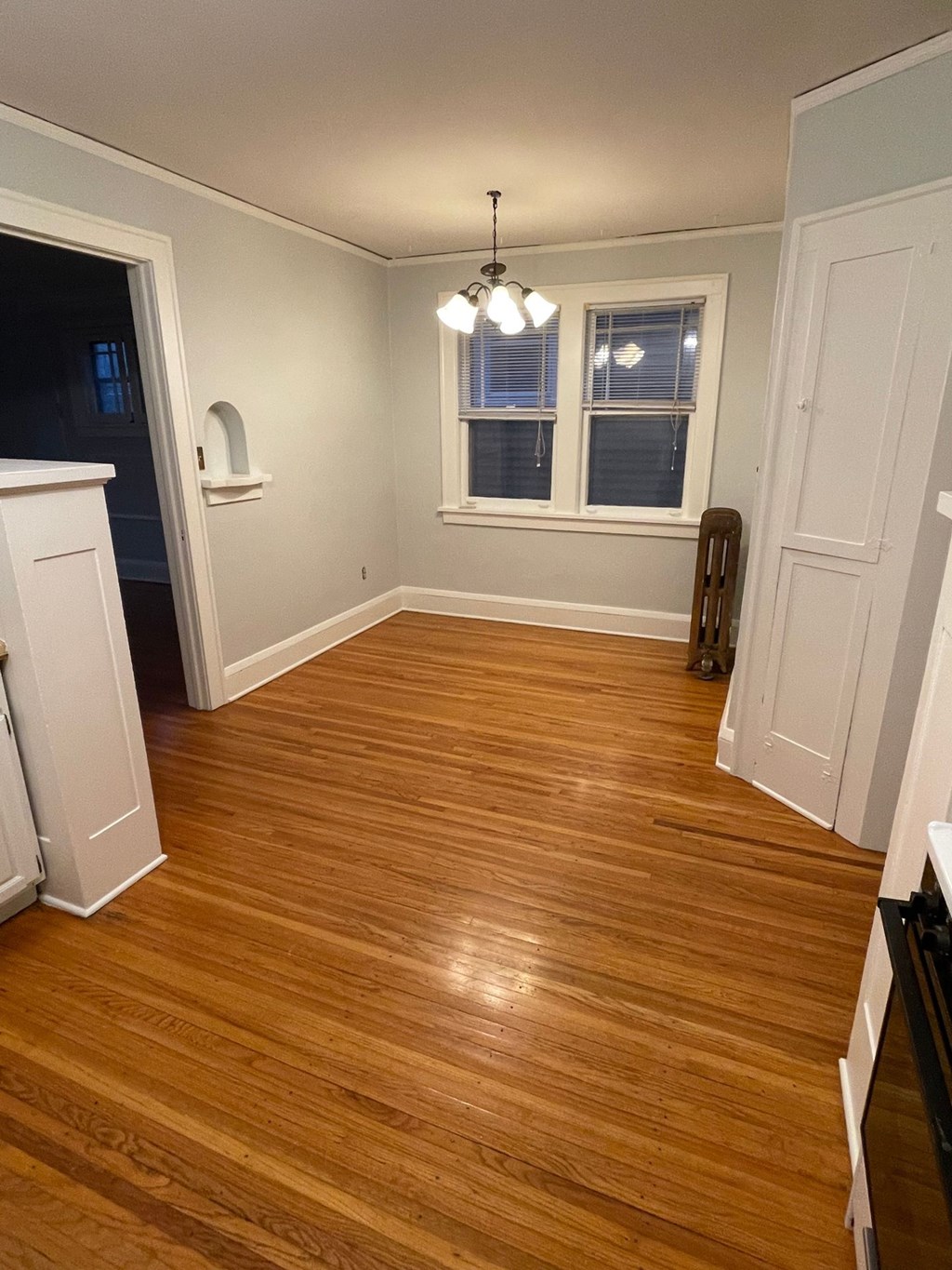 A room with wooden floors and a window.