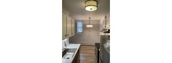 A kitchen with a stainless steel dishwasher and a sink.