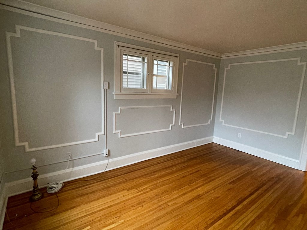 A room with wooden floors and white walls.