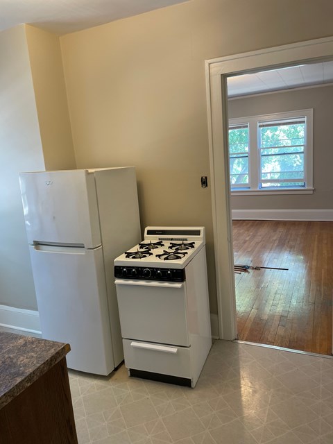 A white refrigerator and stove in a kitchen.