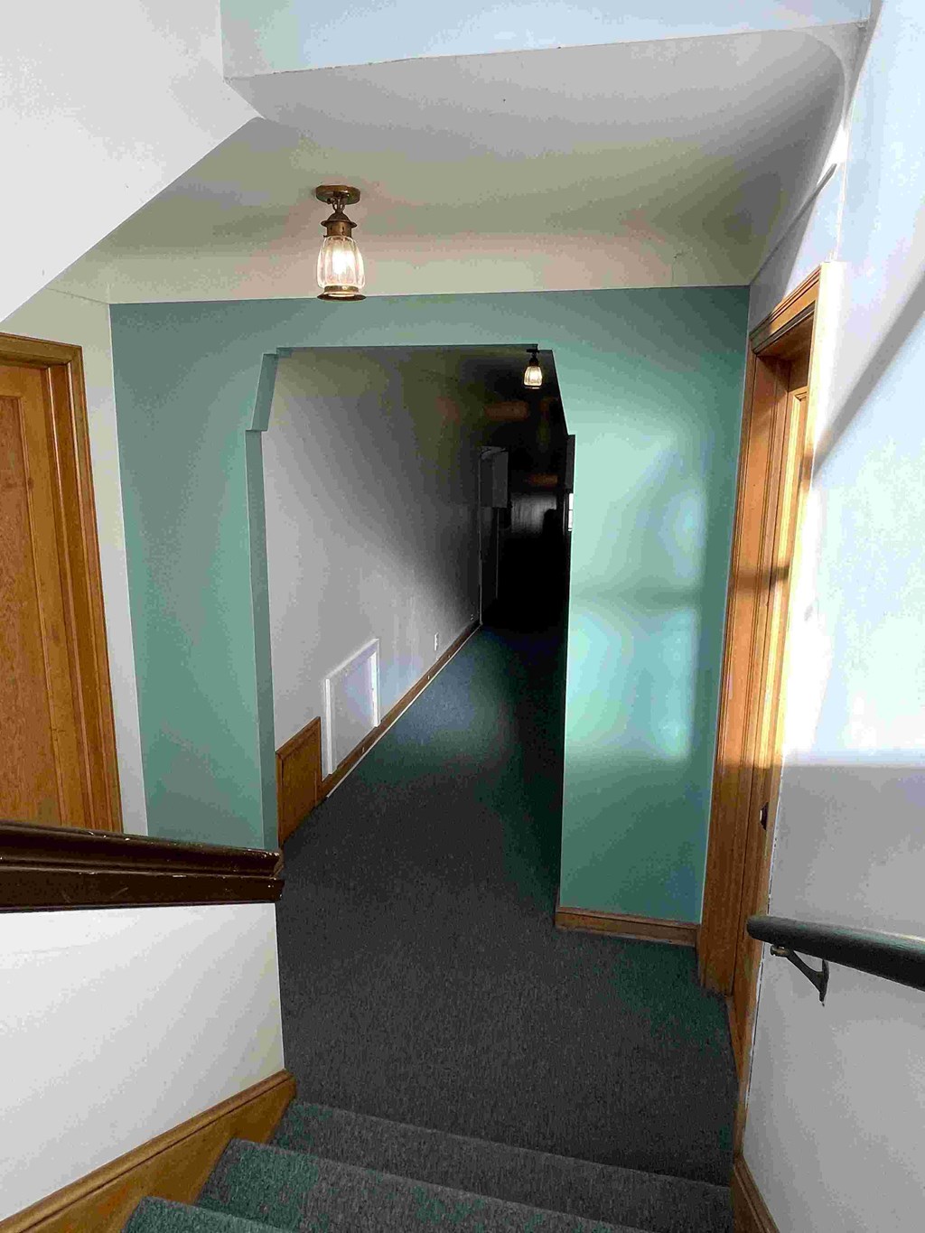 A staircase with a light on the ceiling.