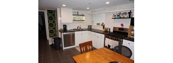 A kitchen with a wooden table and a sign that says "PROSPECT".