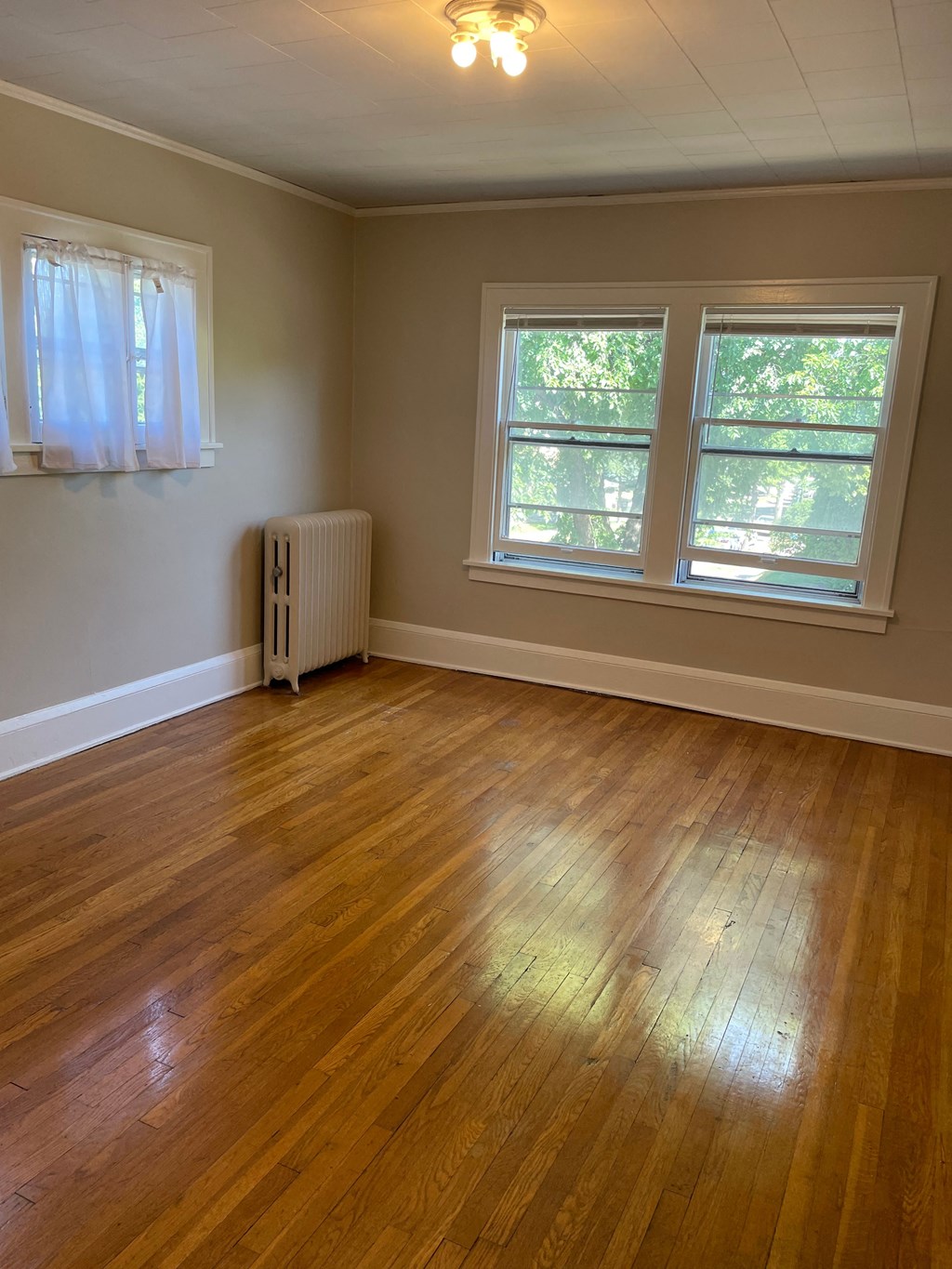 A room with a wooden floor and a window.