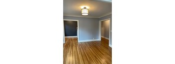 A room with wooden floors and a light fixture.