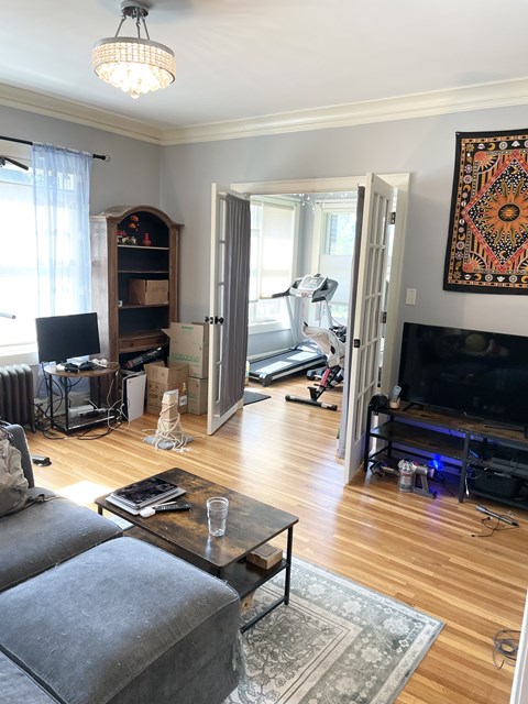 A living room with a grey couch and a coffee table.
