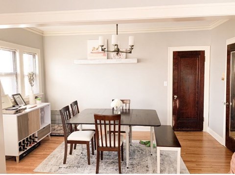 A dining room with a table and chairs.