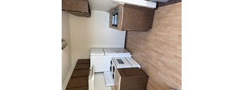 A white stove with a microwave on top of it.