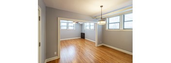 A room with wooden floors and white walls.