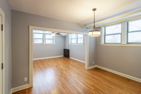 A room with wooden floors and white walls.