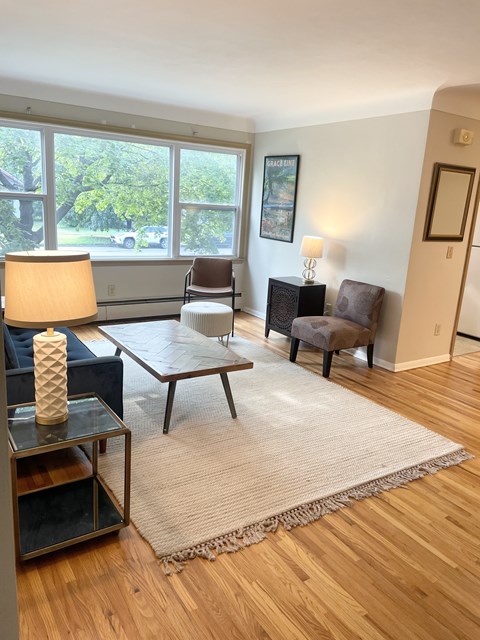 A living room with a couch, chair, and lamp.