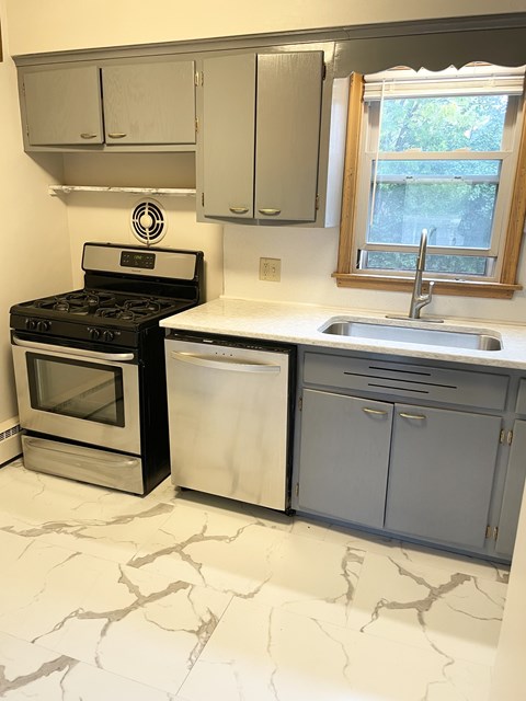 Updated kitchen with new flooring, quartz countertops, stainless steel gas stove and dishwasher, new large basin sink and new faucet.