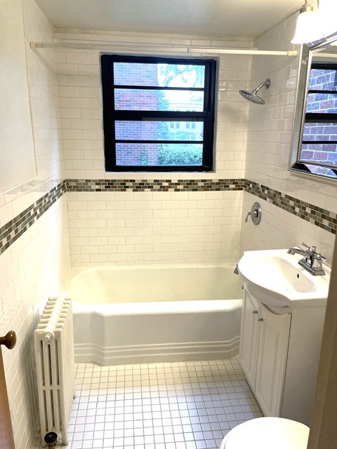 Ceramic tiled bathroom with updated fixtures.