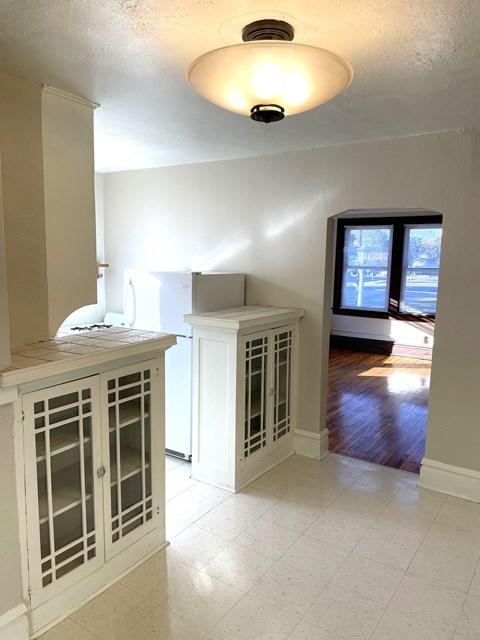 A kitchen with a white cabinet and a window.