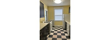 A kitchen with black and white checkered floor.