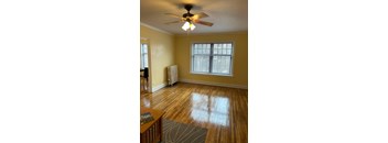 A room with a ceiling fan and a window.