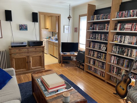 A living room with a bookshelf filled with books.