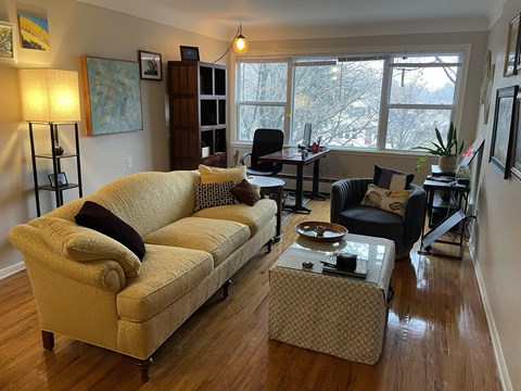 A living room with a tan couch and a coffee table.