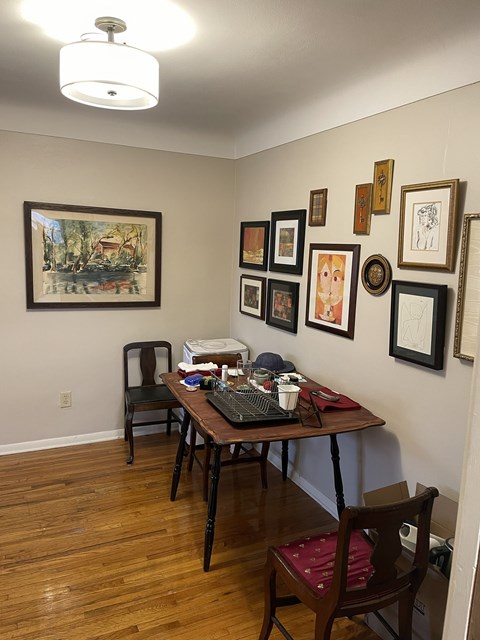 A dining room with a table and chairs.