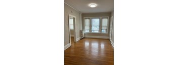 A room with wooden floors and white walls.