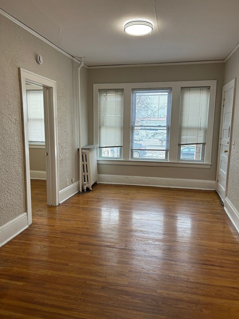 A room with wooden floors and white walls.